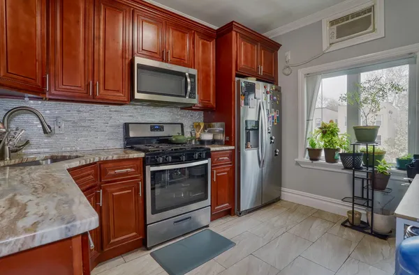 a kitchen with stainless steel appliances granite countertop a refrigerator stove and sink