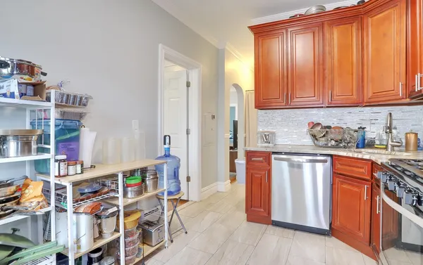a kitchen with stainless steel appliances granite countertop a refrigerator and wooden cabinets