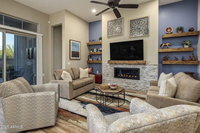a living room with stainless steel appliances kitchen island granite countertop furniture and a kitchen view