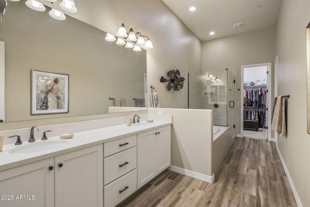 a bathroom with a sink a mirror and a shower