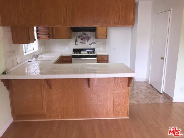 a kitchen with wooden cabinets and a stove