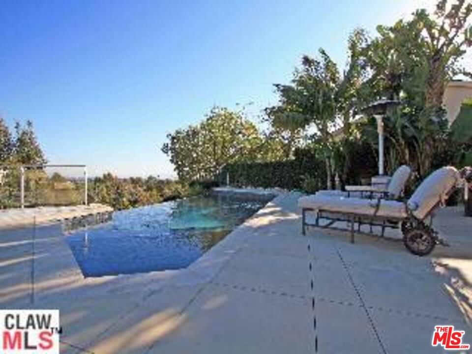 a view of a patio with a table and chairs