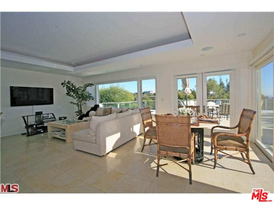 1148 Las Pulgas Road Pacific Palisades, CA 90272 - Photo 5 of 13 a living room with furniture and a flat screen tv