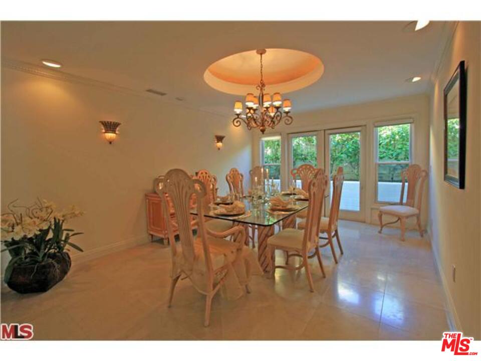 1148 Las Pulgas Road Pacific Palisades, CA 90272 - Photo 6 of 13 a view of a dining room with furniture and chandelier
