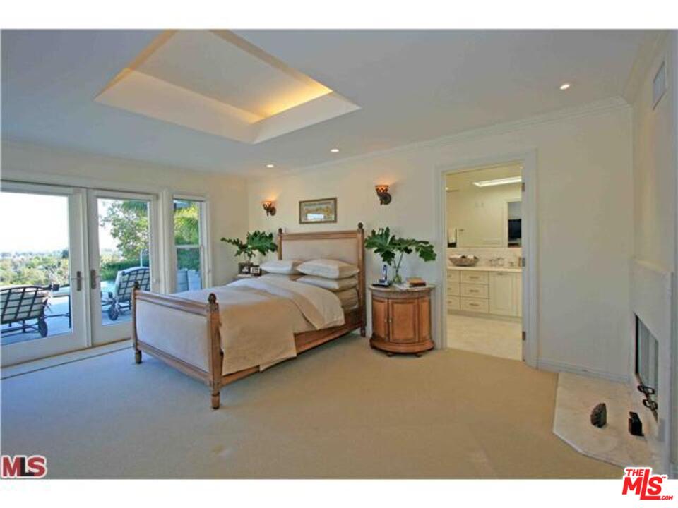 1148 Las Pulgas Road Pacific Palisades, CA 90272 - Photo 7 of 13 a bedroom with a bed and large windows