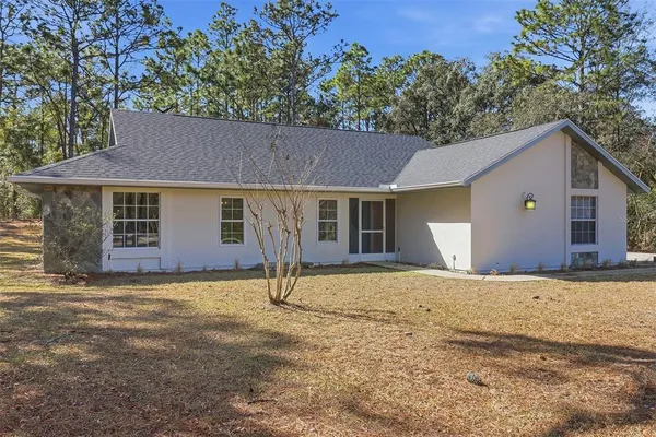 a house with trees in the background