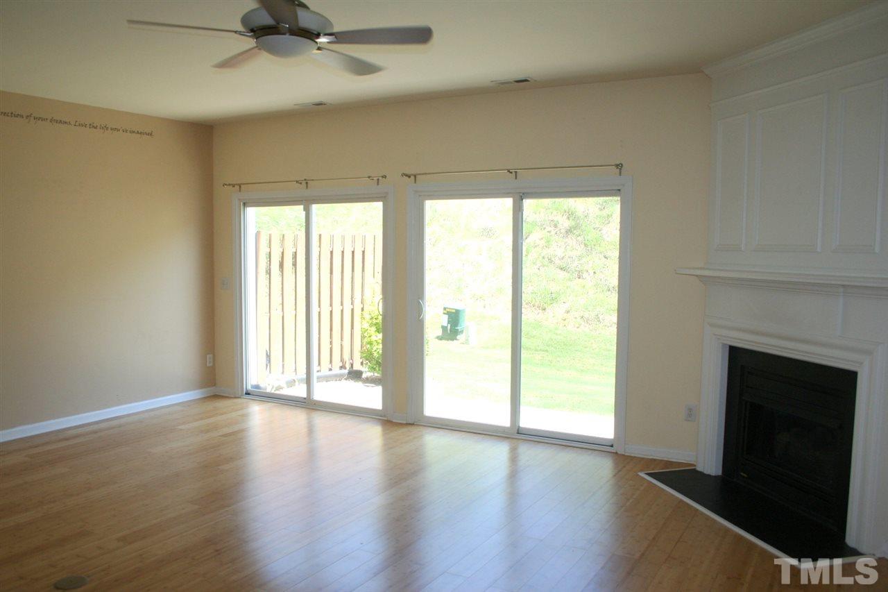 5025 Echo Ridge Road Raleigh, NC 27612 - Photo 8 of 18 a view of an empty room with a window and wooden floor