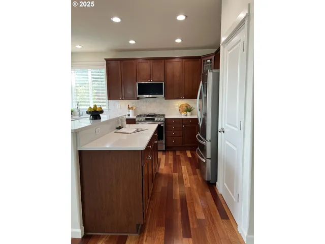 a kitchen with a sink appliances and cabinets