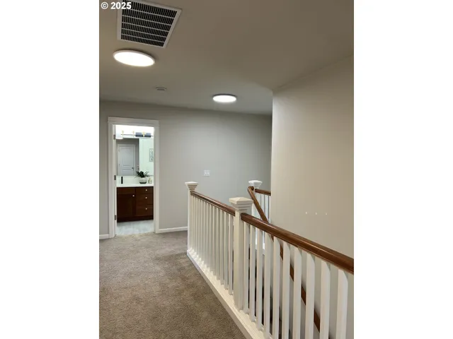 a view of a hallway with a bathroom