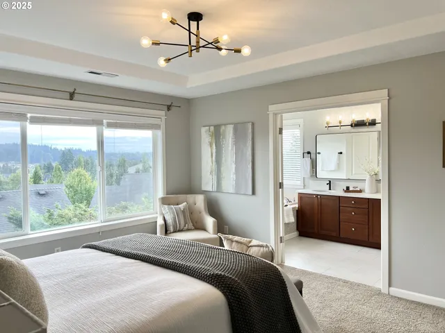 a bedroom with a large bed and a window