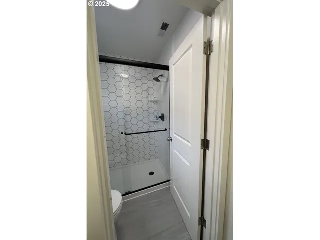 a bathroom with a shower and a sink