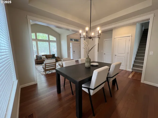 a view of a dining room with furniture wooden floor and chandelier