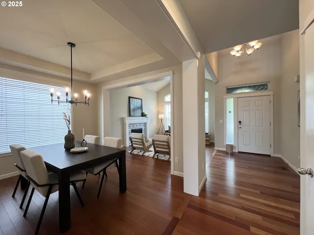 a dining room with furniture and wooden floor