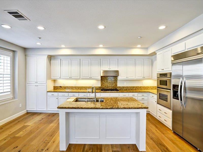 6130 Yardley Lane San Ramon, CA 94582 - Photo 15 of 46 a kitchen with kitchen island granite countertop a sink cabinets and stainless steel appliances