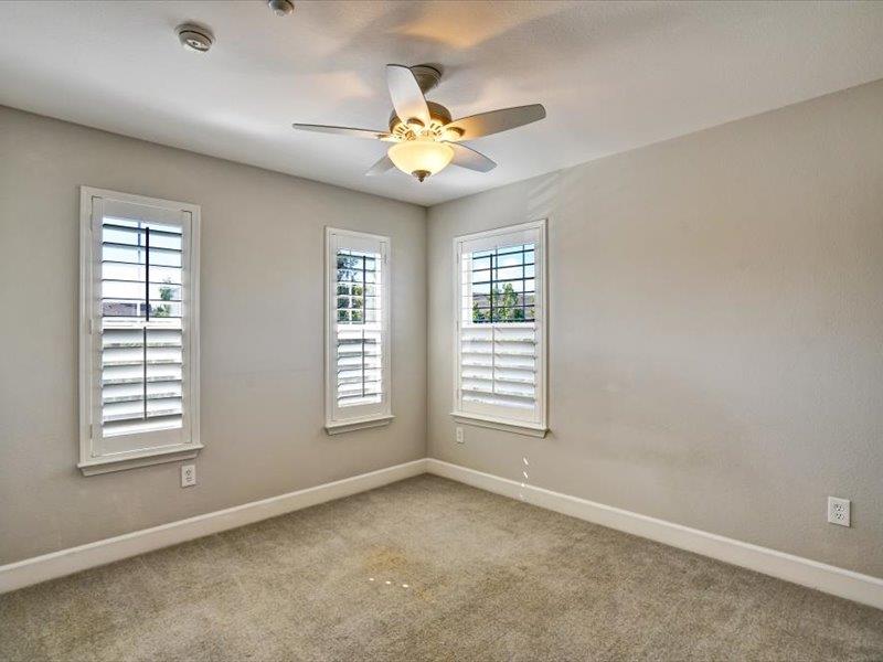 6130 Yardley Lane San Ramon, CA 94582 - Photo 22 of 46 an empty room with windows and chandelier fan