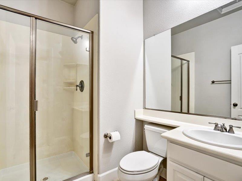 6130 Yardley Lane San Ramon, CA 94582 - Photo 28 of 46 a bathroom with a toilet a sink and a mirror