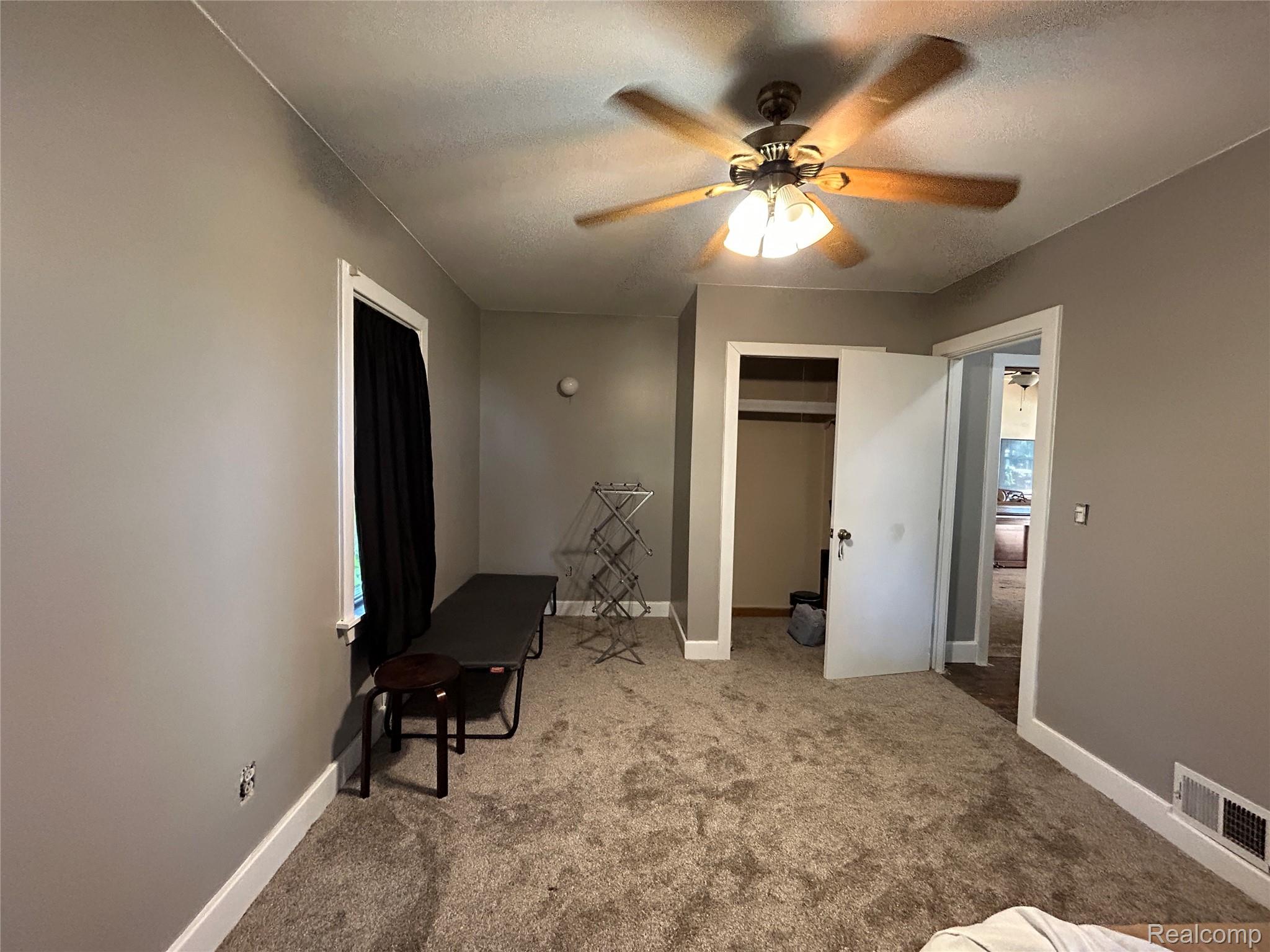 16465 Almont Road Allenton, MI 48002 - Photo 12 of 35 Carpeted flooring, neutral wall color, ceiling fan with light fixture, built-in closet, and white trim