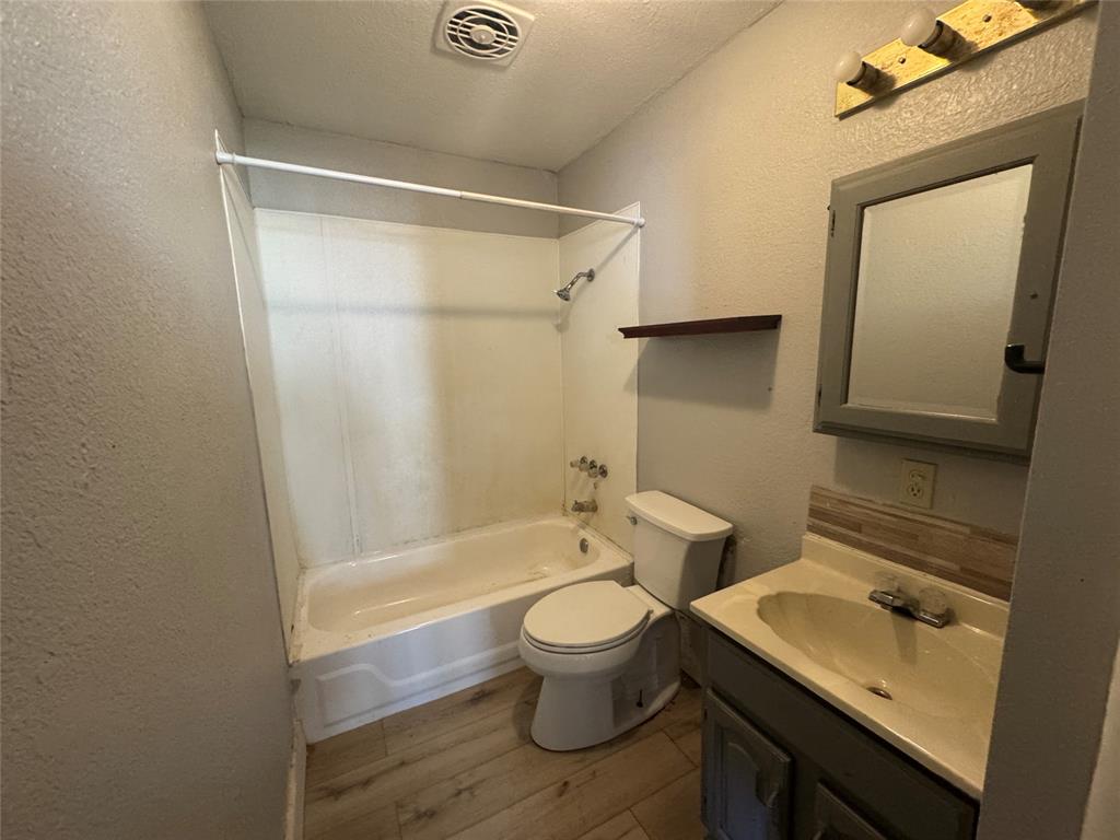 402 North Hughes Street Howe, TX 75459 - Photo 12 of 17 a bathroom with a sink toilet and shower