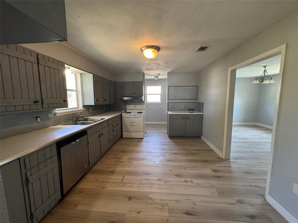 402 North Hughes Street Howe, TX 75459 - Photo 16 of 17 a large kitchen with stainless steel appliances a sink and cabinets
