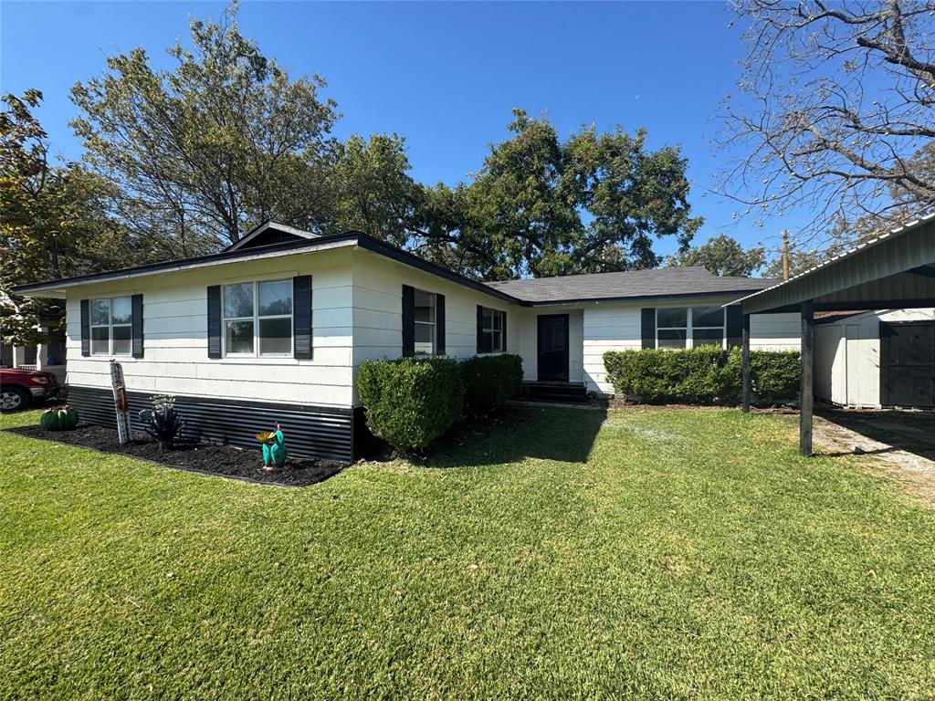 402 North Hughes Street Howe, TX 75459 - Photo 3 of 17 a view of a house with a backyard and a patio