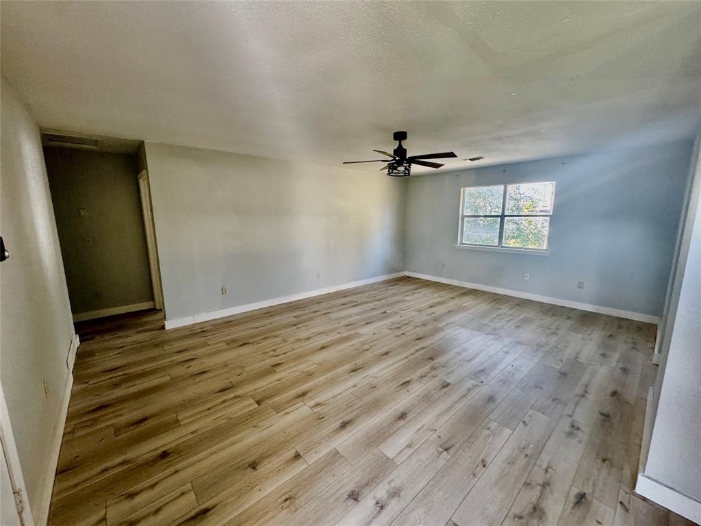 402 North Hughes Street Howe, TX 75459 - Photo 4 of 17 wooden floor in an empty room