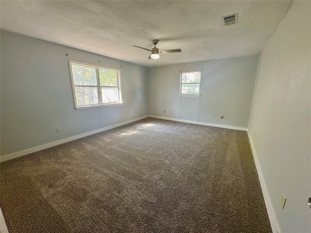 402 North Hughes Street Howe, TX 75459 - Photo 5 of 17 an empty room that has a window