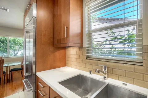 a kitchen with a sink cabinets and a large window
