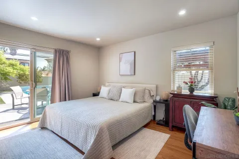 a bedroom with a large bed and a window