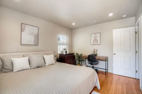 a bedroom with bed and a table