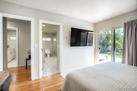 a bedroom with a bed and glass door