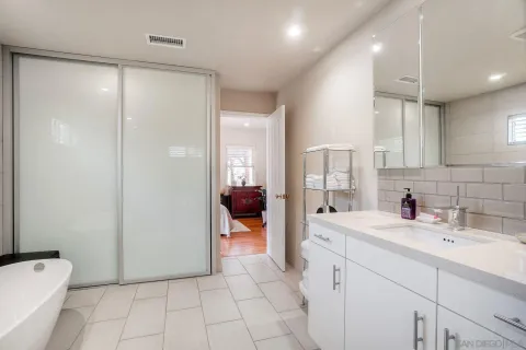a bathroom with a sink a toilet and a large mirror