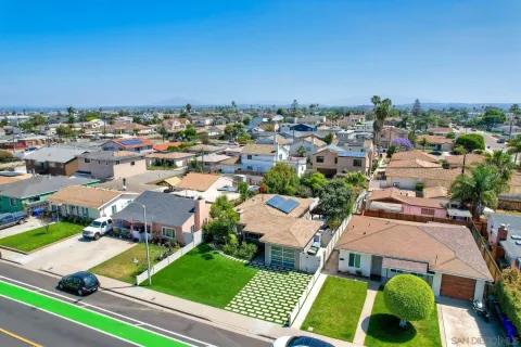 an aerial view of a house with garden space and street view