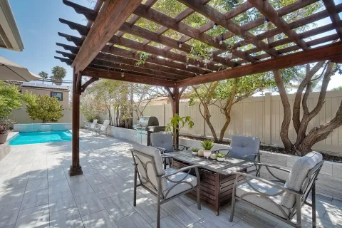 a view of a patio with a table chairs and a backyard
