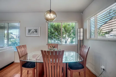 a view of a dining room with furniture a chandelier and wooden floor