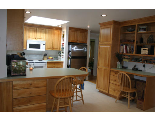 243 Hudson Road Sudbury, MA 01776 - Photo 3 of 6 a kitchen with a table chairs refrigerator and cabinets