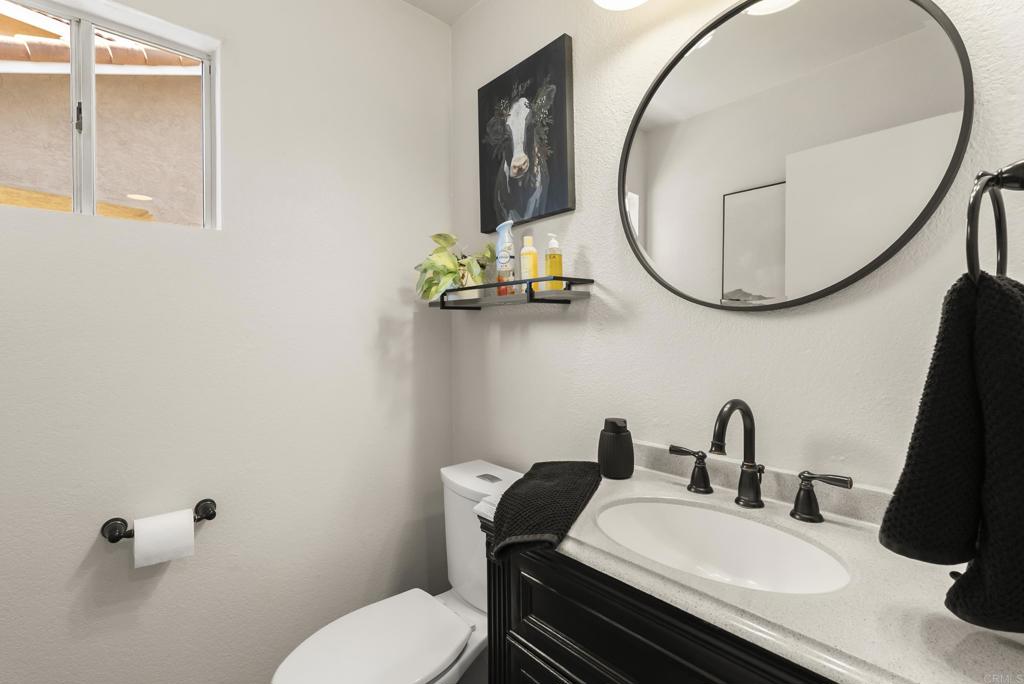 2225 Baxter Canyon Road Vista, CA 92081 - Photo 19 of 46 a bathroom with a sink mirror and toilet