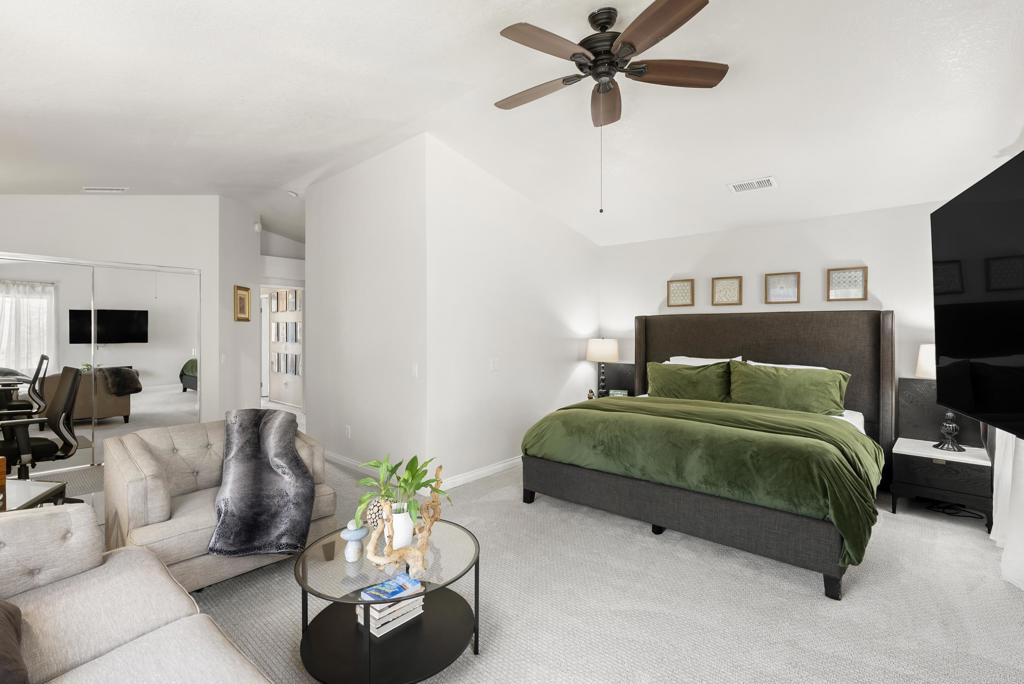 2225 Baxter Canyon Road Vista, CA 92081 - Photo 22 of 46 a bedroom with a bed a couch and a flat screen tv