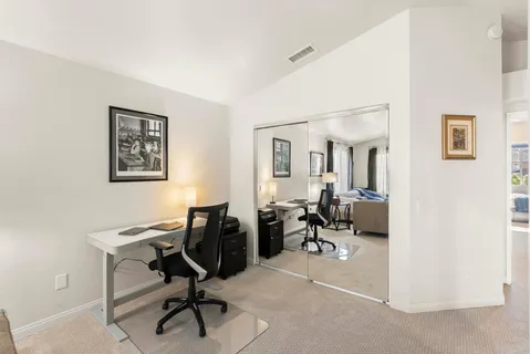 a view of walk in closet with clothes