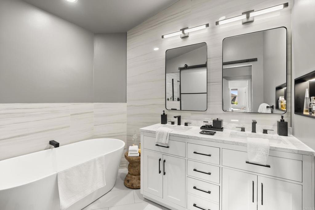 2225 Baxter Canyon Road Vista, CA 92081 - Photo 28 of 46 a bathroom with a double vanity sink mirror and bathtub