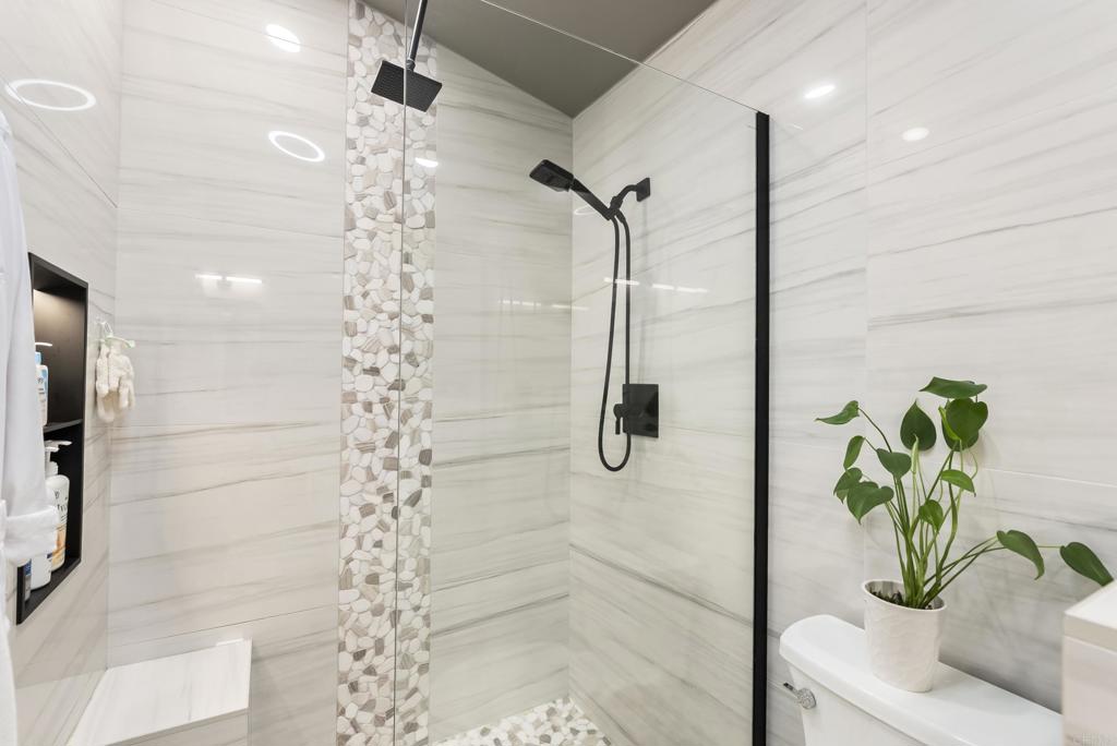 2225 Baxter Canyon Road Vista, CA 92081 - Photo 30 of 46 a white bath tub sitting in a bathroom next to a shower