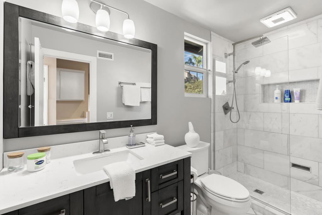 2225 Baxter Canyon Road Vista, CA 92081 - Photo 32 of 46 a bathroom with a sink a toilet and shower