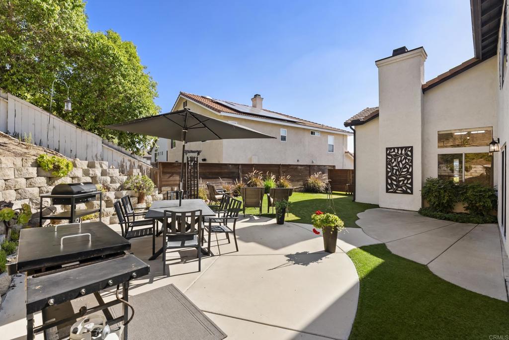2225 Baxter Canyon Road Vista, CA 92081 - Photo 38 of 46 a view of a patio with table and chairs under an umbrella