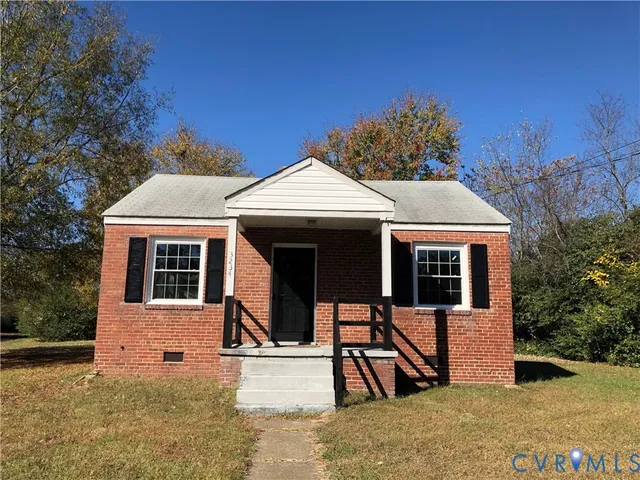 a view of a house with wooden fence