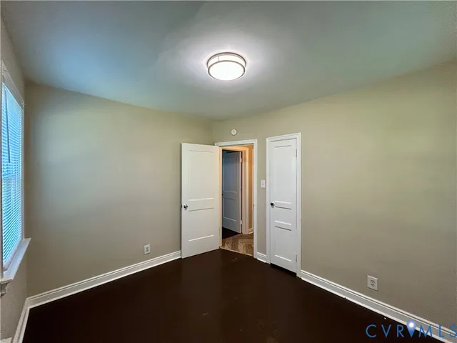 an empty room with closet area