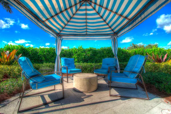 a building outdoor space with patio furniture and potted plants