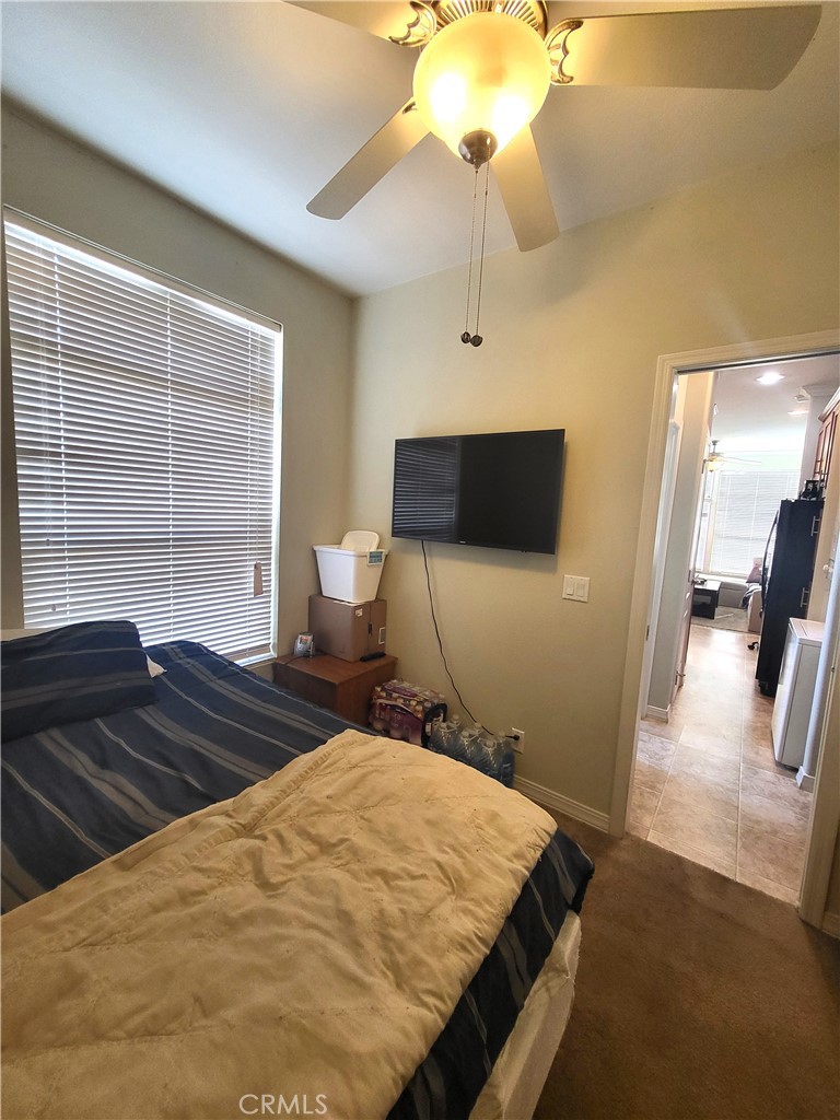 2103 West 245th Street, Unit 10 Torrance, CA 90717 - Photo 15 of 21 a bedroom with a bed and a chandelier