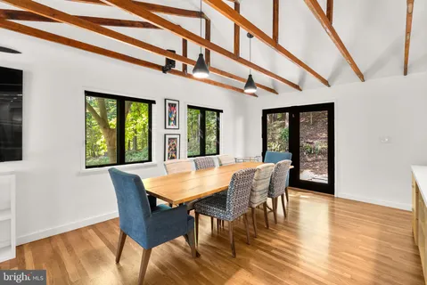 a view of a dining room with furniture window and wooden floor