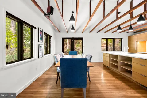 a large hall with wooden floor and windows