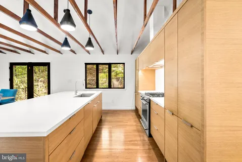 a spacious bedroom with a large bed and a large window