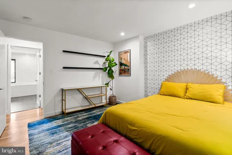 a bedroom with a bed and wooden floor